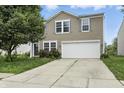 Inviting two-story home with a well-maintained lawn and a two-car garage at 1236 N Aberdeen Dr, Franklin, IN 46131