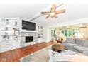 Inviting living room featuring a fireplace, built-in shelving, and comfortable seating area at 1237 Driftwood Dr, Carmel, IN 46033