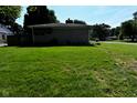 Exterior shot of home showing side yard with mature trees and greenery at 136 W Loretta Dr, Indianapolis, IN 46217