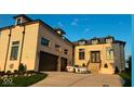 Elegant brick home with a two-car garage, featuring a wrought iron door and a sports car at 16512 Grand Cypress Dr, Noblesville, IN 46060
