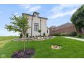 Beautifully landscaped yard featuring a retaining wall made of rocks, green grass and manicured landscaping at 16512 Grand Cypress Dr, Noblesville, IN 46060