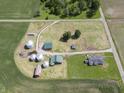 Aerial view of farm with cultivated field, multiple buildings, silos, and mature trees at 17550 N 200 W, Summitville, IN 46070