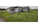 Exterior view of white sided home with shed and partial lawn at 17550 N 200 W, Summitville, IN 46070