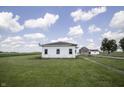 Exterior view of white sided home with shed and barn in background at 17550 N 200 W, Summitville, IN 46070