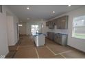 Unfinished, spacious kitchen with center island, modern gray cabinetry and plenty of room to dine at 1817 Real St, Indianapolis, IN 46240