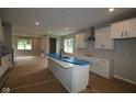 Open kitchen featuring white cabinets, a large island, and modern fixtures, great for entertaining at 1821 Real St, Indianapolis, IN 46240