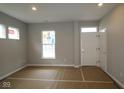 Bright living room featuring large windows and a freshly painted interior, ready for customization at 1821 Real St, Indianapolis, IN 46240