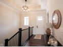Warm foyer featuring wood floors, staircase, and a view of the front door and decorative mirror at 1872 Wellpark Dr, Westfield, IN 46074