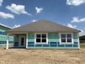 Spacious backyard view of a home under construction, showing large windows and a door at 188 Springfield Xing, Greenfield, IN 46140