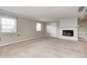Spacious carpeted basement featuring a white brick fireplace, windows, and neutral paint at 303 E County Road 500 N, Pittsboro, IN 46167