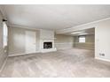 Expansive carpeted basement with a white brick fireplace, multiple windows, and a neutral color scheme at 303 E County Road 500 N, Pittsboro, IN 46167