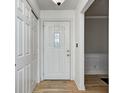 Bright foyer with white front door, hardwood floors, closet, and access to other rooms at 303 E County Road 500 N, Pittsboro, IN 46167