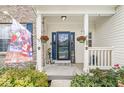 Charming front porch with decorative plants, patriotic decor, and a welcoming entrance at 360 Myers Lake Dr, Noblesville, IN 46062