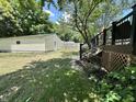 The backyard has a wooden bench, a shed, a fence, and lush greenery with lots of sunlight at 388 N Ohio St, Martinsville, IN 46151
