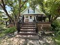 This home has a wooden deck and stairs with a large backyard, and is surrounded by lush greenery at 388 N Ohio St, Martinsville, IN 46151
