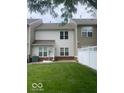 Exterior view of a townhome backyard with grass and a partial brick paver patio at 459 Dekalb Dr, Westfield, IN 46074