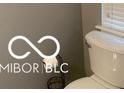 Bathroom with a white toilet, gray walls, and a chrome toilet paper holder at 459 Dekalb Dr, Westfield, IN 46074