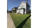A charming home boasts a lush green lawn and inviting curb appeal at 46 S Warman S Ave, Indianapolis, IN 46222