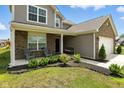 Charming two-story home featuring a cozy covered porch with seating and beautifully landscaped front yard at 4643 Darla Ct, Indianapolis, IN 46239