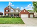 Charming two-story brick home with a well-manicured lawn, beautiful landscaping, and a three car attached garage at 564 Gainesway N Dr, Greenwood, IN 46142