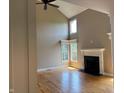Spacious living room with a fireplace, hardwood floors, and lots of natural light at 5775 Coopers Hawk Dr, Carmel, IN 46033