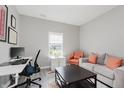 Cozy living room with neutral tones, desk space, comfortable seating, and abundant natural light at 5809 Terracotta Trce, McCordsville, IN 46055