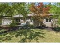 Charming brick home with mature trees, manicured landscaping, and an attached two-car garage at 604 Oak Blvd W Dr, Greenfield, IN 46140
