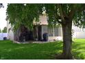 Expansive backyard featuring a covered patio area and mature tree providing shade for relaxation at 6161 E Runnymede Ct, Camby, IN 46113