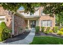 Inviting entrance with a landscaped walkway leading to the front door, enhancing curb appeal at 6465 Robinsrock Dr, Indianapolis, IN 46268