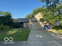 Lovely one-story home with a manicured lawn, featuring an attached two-car garage at 7231 N Orchard Dr, Indianapolis, IN 46236
