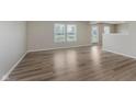 A bright, open living room with wood-look vinyl plank flooring and many windows at 7572 Wymm Ln, Ingalls, IN 46048