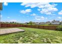 Large fenced backyard features a wooden deck, perfect for outdoor entertaining and play at 7865 Danube St, Indianapolis, IN 46239