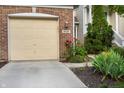 Close up of brick garage, driveway and lovely flowers, with the house number clearly displayed at 9525 Longwell Dr, Indianapolis, IN 46240