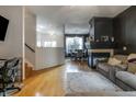 Open-concept living room with hardwood floors, fireplace, and dining area, perfect for entertaining at 9525 Longwell Dr, Indianapolis, IN 46240