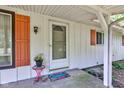 Close-up of a welcoming front porch with decorative plants and a 'Welcome' mat at 10065 E 25Th St, Indianapolis, IN 46229