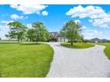 Long driveway leads to a beautiful home with mature trees, landscaping, and a large lawn at 11250 N 600 W, Fountaintown, IN 46130
