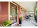 Inviting front porch with brick accents, seating, and stylish lighting at 11424 Green St, Carmel, IN 46033
