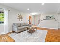 Bright living room features hardwood floors and staircase at 11424 Green St, Carmel, IN 46033