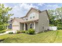 Inviting two-story home with a well-manicured lawn and an attached two car garage at 1156 Brockton Ct, Greenfield, IN 46140