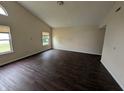 Bright living room featuring modern flooring, neutral walls, and large windows at 11726 Pawleys Ct, Indianapolis, IN 46235