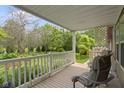 Charming covered porch with a scenic view of the lush front yard and surrounding greenery at 12222 Cable Dr, Indianapolis, IN 46236