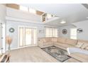 Bright living room with high ceilings, neutral colors, and access to the backyard at 1302 Main St, Elwood, IN 46036