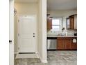 View of the kitchen with stainless steel appliances and a white entry door at 1331 Mccormicks Cir, Danville, IN 46122