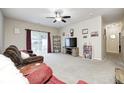 Spacious living room with sliding door to backyard and ceiling fan at 1331 Mccormicks Cir, Danville, IN 46122