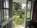 Open front door and screen revealing the yard of the home at 1433 N Colorado Ave, Indianapolis, IN 46201