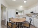 Bright eat-in kitchen features white cabinetry, neutral counters and flooring, and modern appliances at 15388 Dry Creek Rd, Noblesville, IN 46060