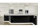 Bright kitchen featuring white cabinets, stainless steel appliances, and a black decorative island at 16057 Coleman Dr, Westfield, IN 46074