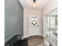 Charming foyer features detailed accent wall, a wreath on the front door, and glass french doors at 17390 Tribute Row, Noblesville, IN 46060