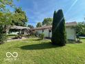 Landscaped backyard featuring a pergola with a picnic table at 1919 Manor Dr, Lebanon, IN 46052