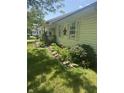 Landscaped front yard with flowering plants and mature bushes at 1919 Manor Dr, Lebanon, IN 46052